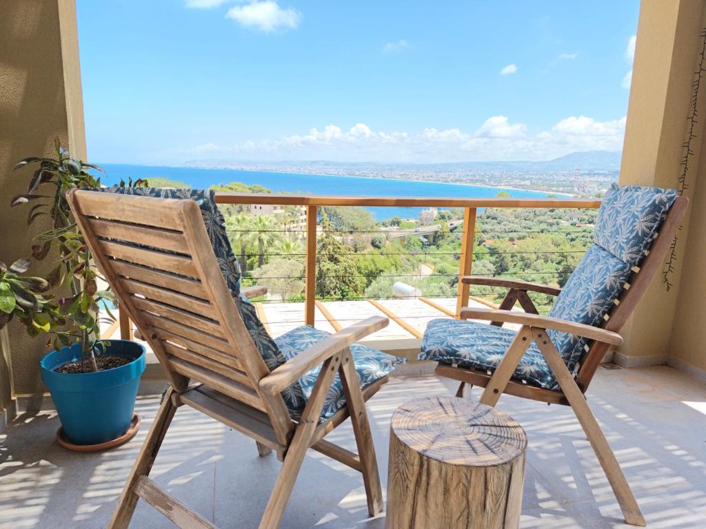two chairs on a balcony with a view of the ocean at my suite home in Heraklio