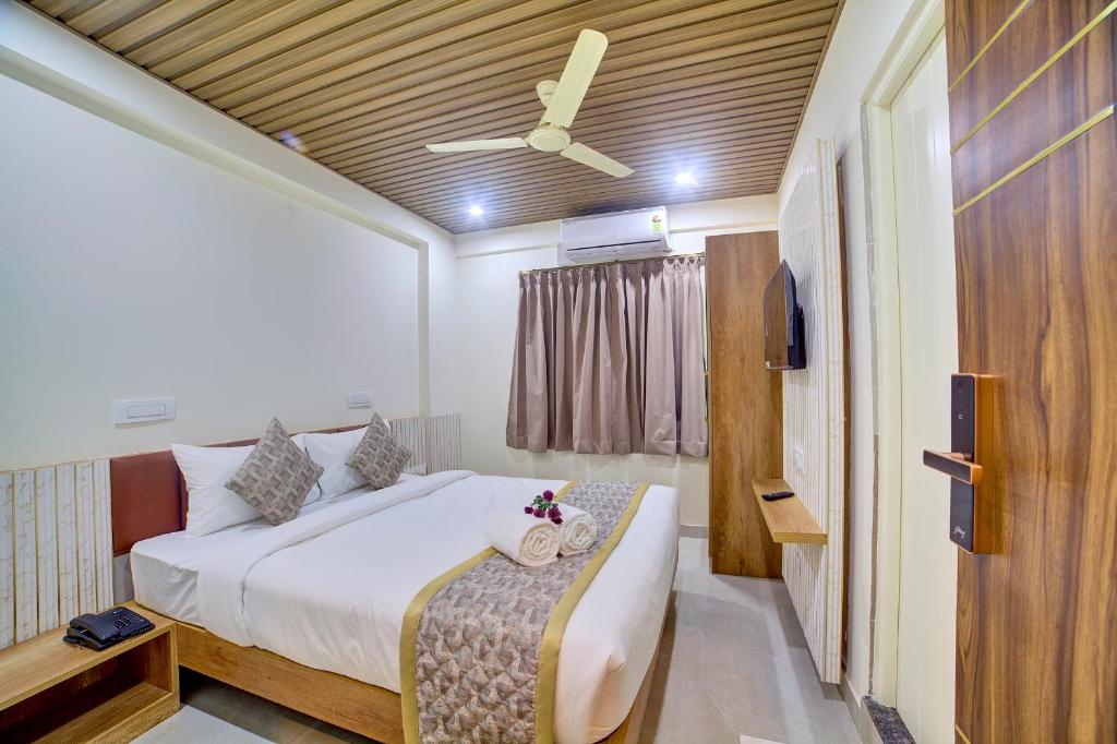 a bedroom with a bed and a ceiling fan at RedKEY Inn Hotel Bangalore Airport in Bangalore