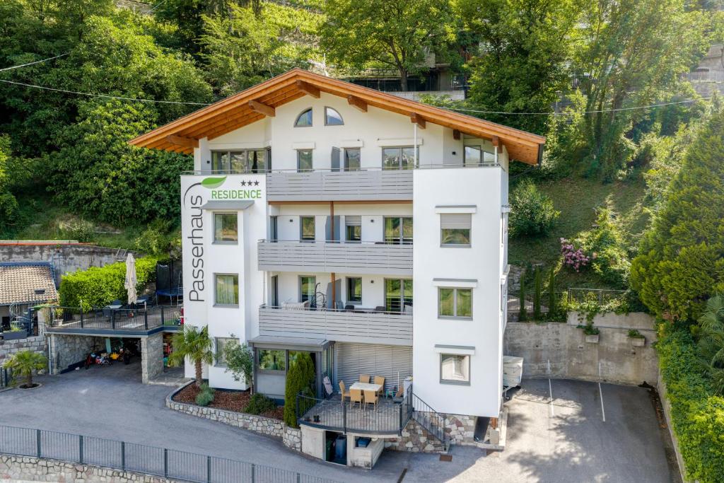 an aerial view of a white building with a roof at Residence Passerhaus in Schenna
