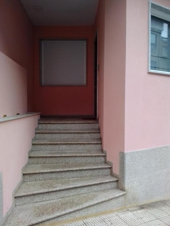 a set of stairs leading to a red door at Apartamentos arcade in Arcade