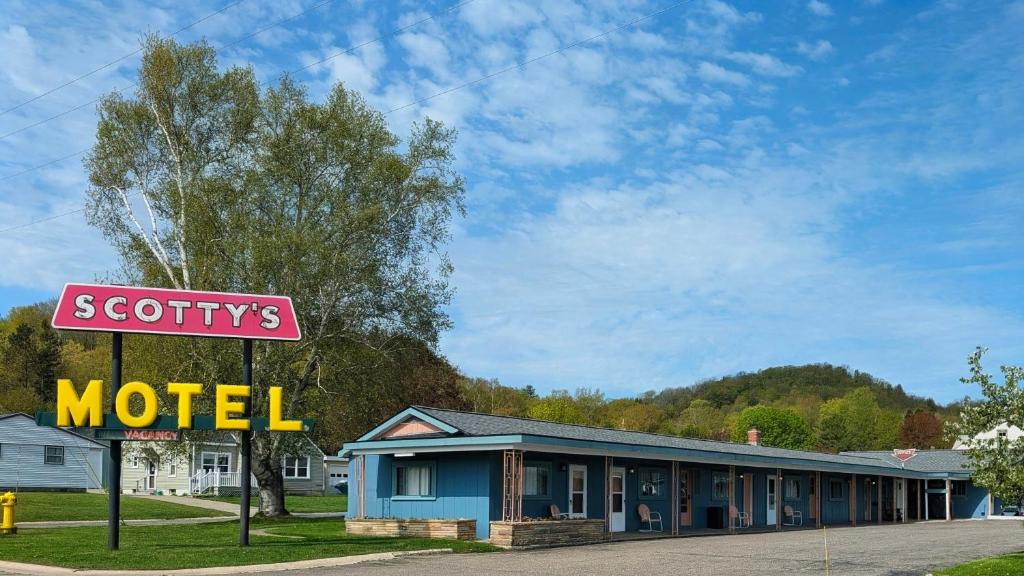 a motel sign in front of a motel at Scotty's Motel in Munising