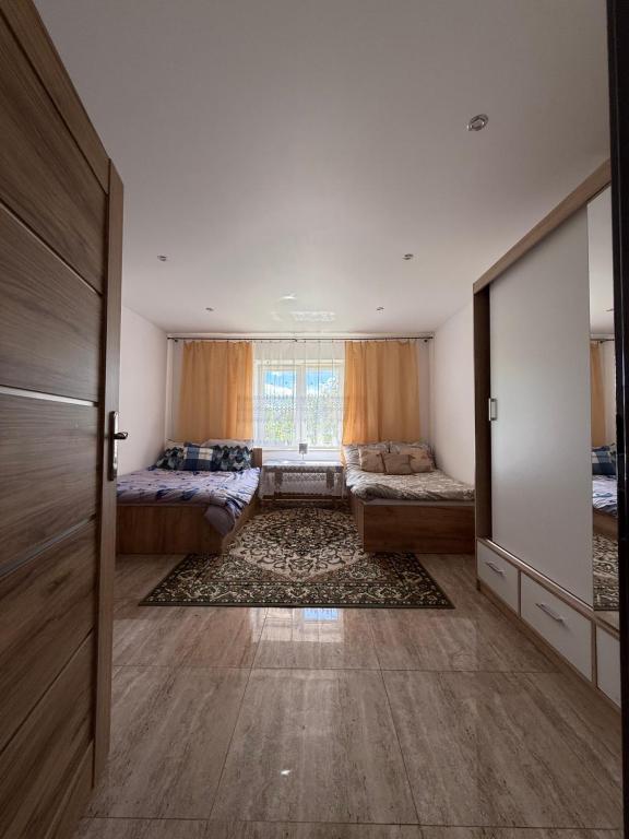 a large room with two beds and a window at 9 Dańce - comfortable accommodation 22-220 - WIFI included in Dańce