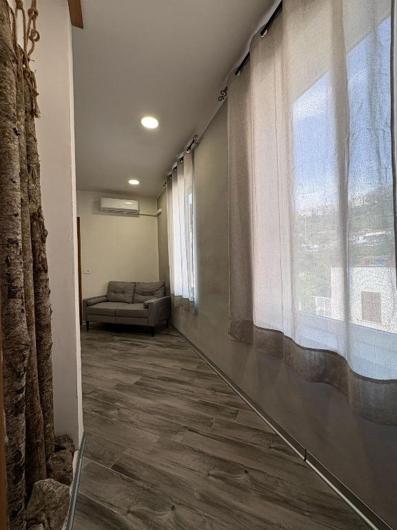a hallway with a couch and a large window at La casa del Borgo in Cetraro