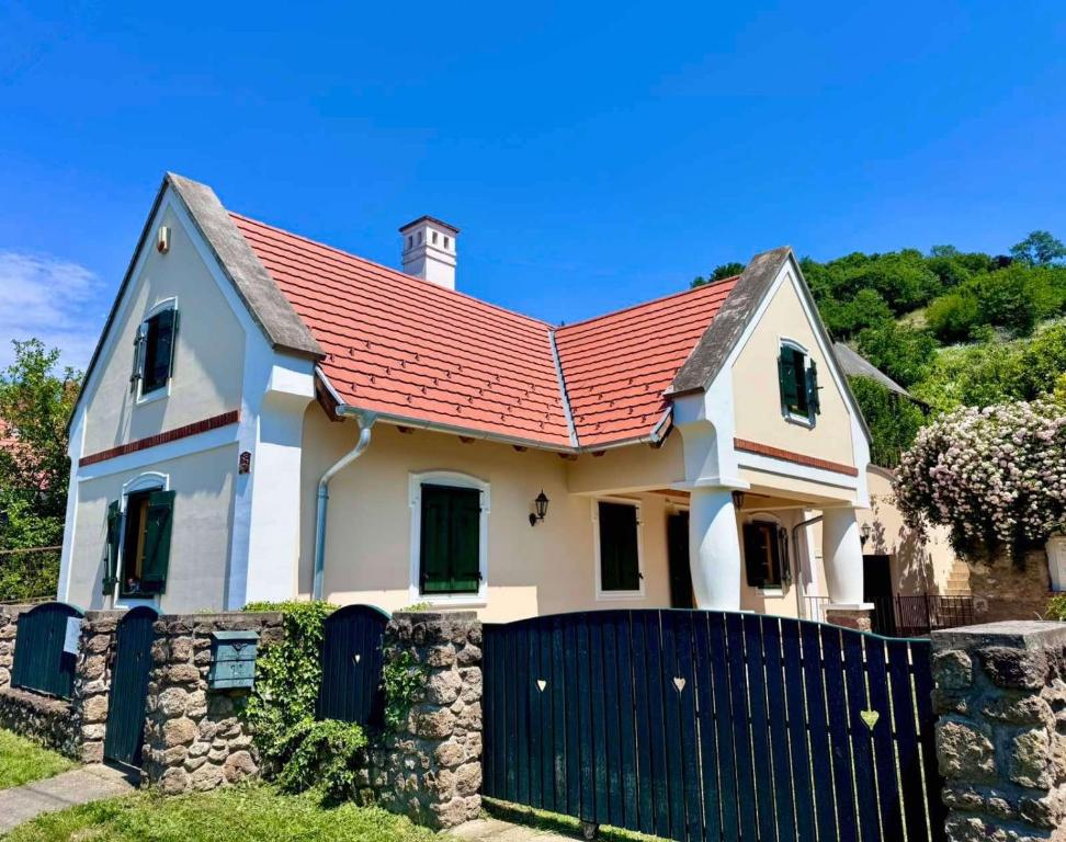 a house with a red roof and a fence at The Szigliget Residence in Szigliget