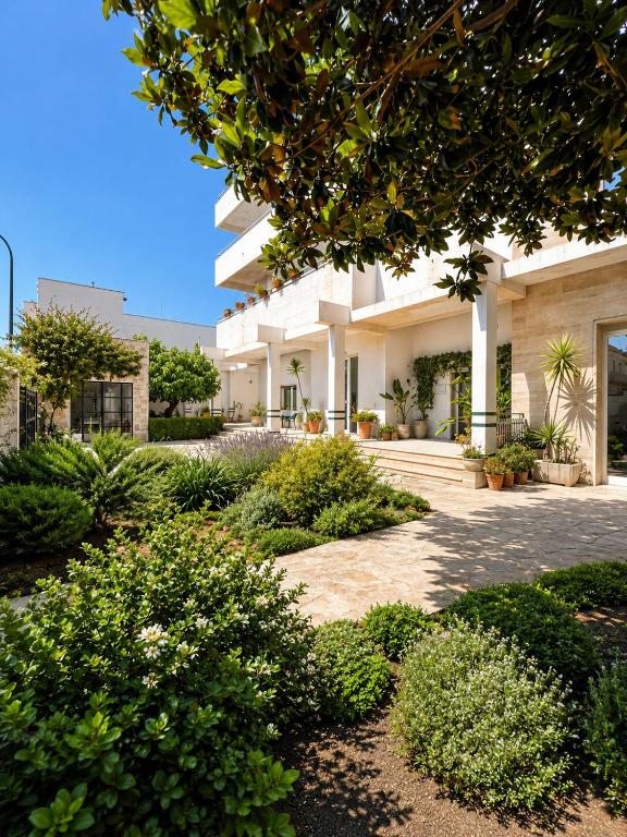 a view of a building with bushes and trees at Canneddi Boutique Farm in Avetrana