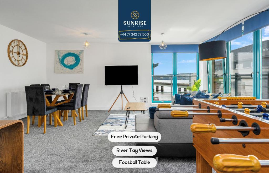 a living room with a couch and a table at PENTHOUSE - Spacious, Stunning River Views, Foosball Table, Central, River Front, V&A, Train Station, City Centre, Lift Access, Free Parking & Fully Equipped by SUNRISE LONG LETS and SERVICED ACCOMMODATION DUNDEE - Reduced Mobile App Price in Dundee
