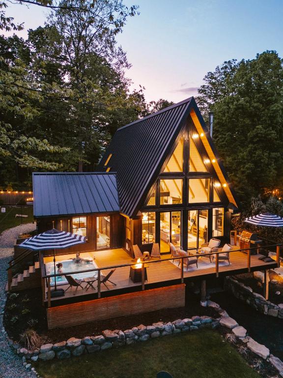 a large wooden house with a black roof at Paddle Point in West Milford