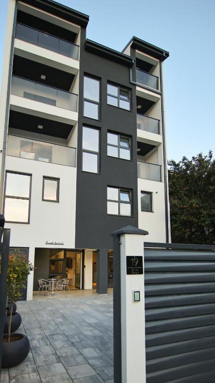 a black and white building with a lot of windows at RiverSide Apartments in Veles