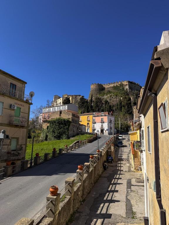 a street in a town with a hill in the background at Guest House Maramà in Belvedere Marittimo