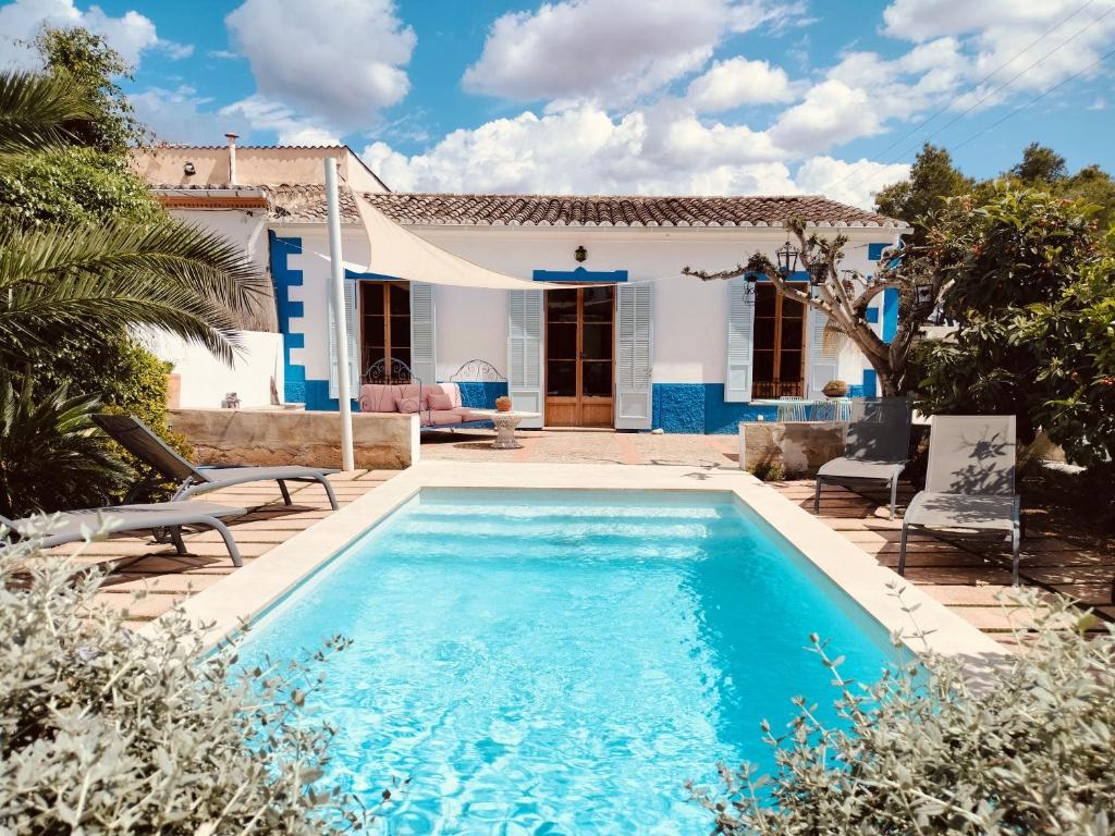 a villa with a swimming pool in front of a house at Villa Palma - Establiments by PriorityVillas in Palma de Mallorca
