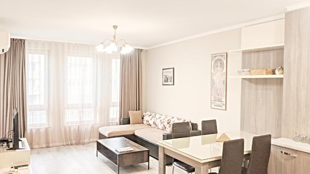 a living room with a table and a couch at Lux 2 Central Apartment with Garage in Plovdiv