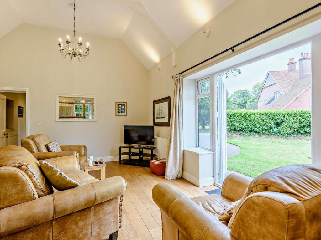 a living room with two couches and a large window at 2 Bed in Blandford Forum oc-83814 in Morden