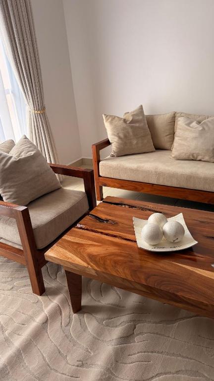 a living room with a couch and a table at ValdOrea Residences in Entebbe