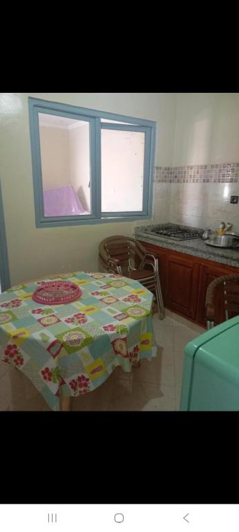 a kitchen with a table with a table cloth on it at Saïdafriends in Saïdia