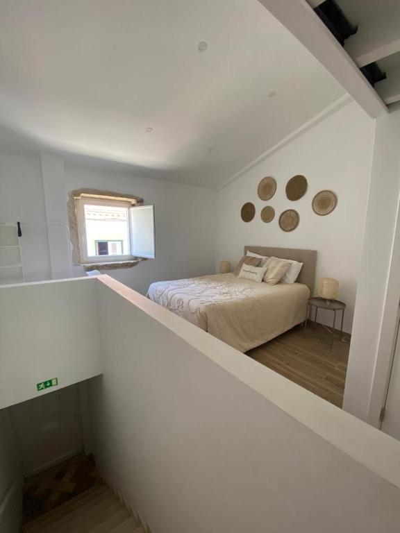 a bedroom with a bed in a white room at Tomarhousing Heritage in Tomar