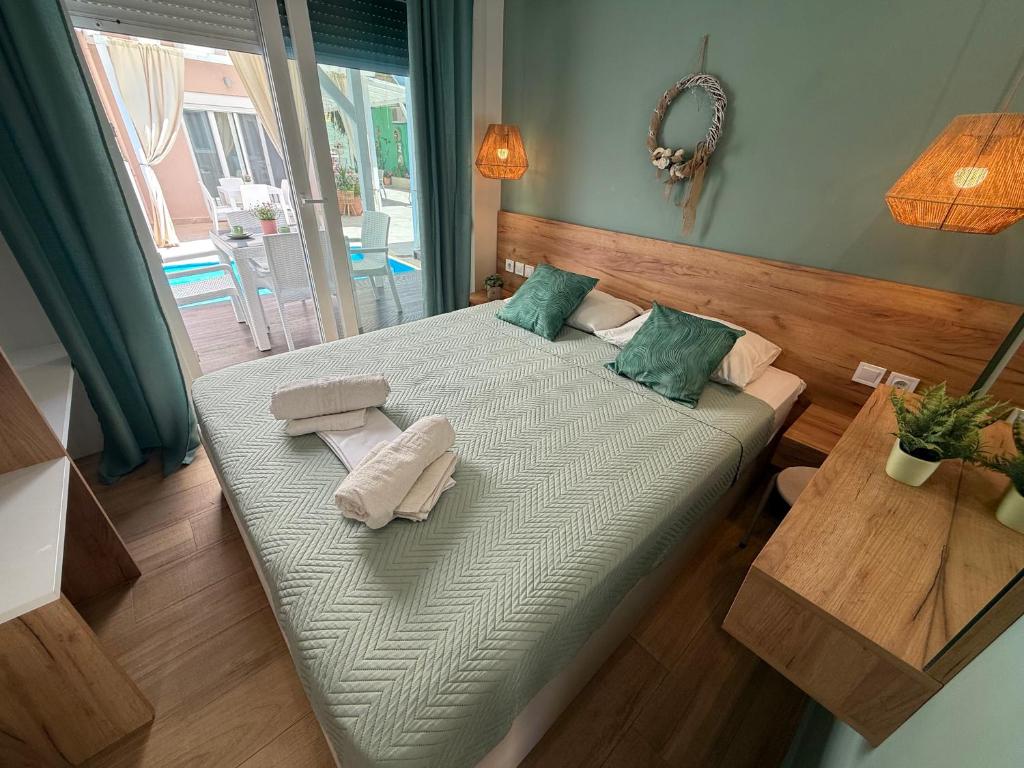 a bedroom with a bed with two towels on it at ΑVLI Superior Studio Sarti no6 in Sarti