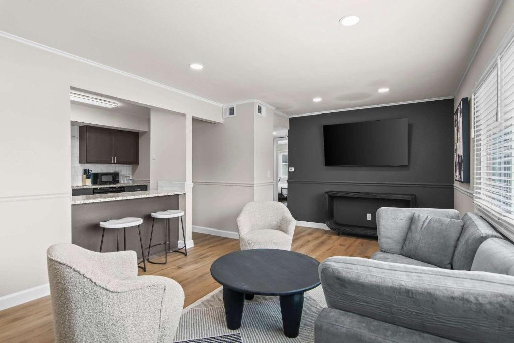 a living room with a couch and a table at Newly Renovated Unit in Central Spfld #204 in Springfield