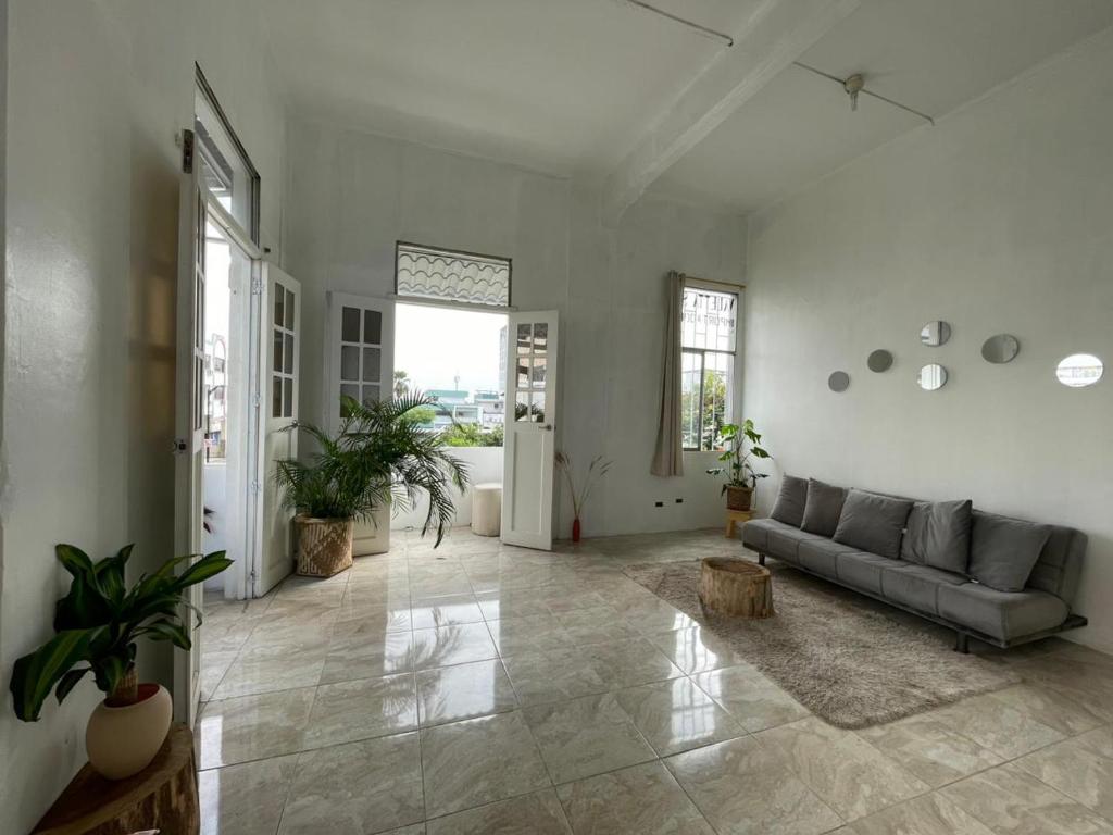 a living room with a couch and some plants at Pachamic House in Guayaquil
