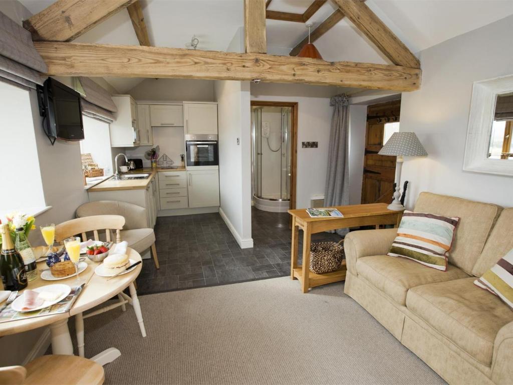 a living room with a couch and a table at 1 Bed in Ripon oc-g0023 in Winksley