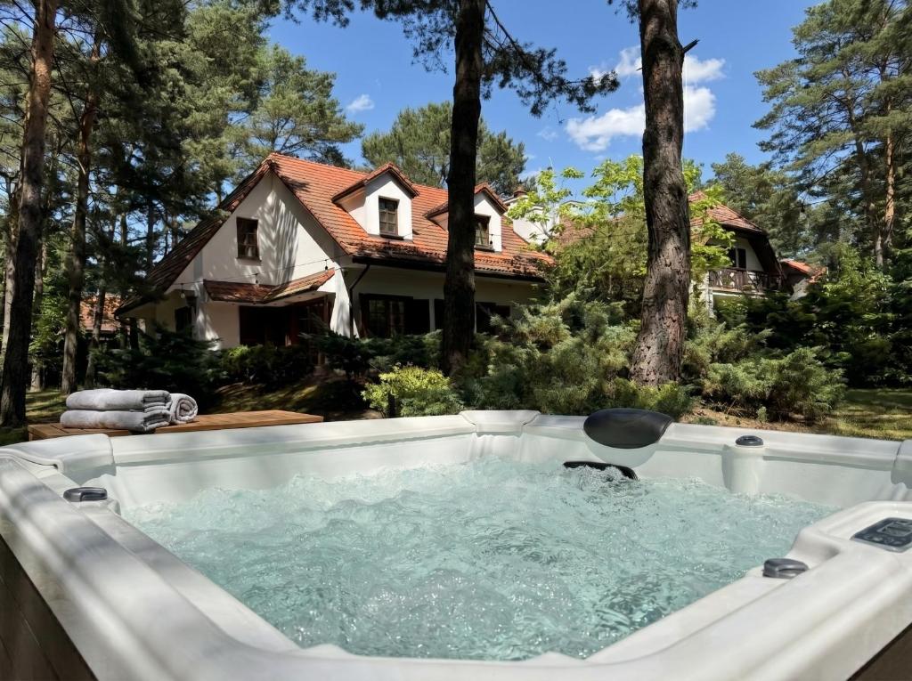a hot tub in the backyard of a house at Golden Villas Luxury Garden Retreat - Jacuzzi & Sauna in Konstancin-Jeziorna