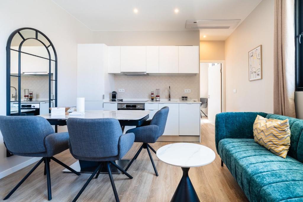 a living room with a couch and a table at GuestReady – Steps from Sand • Champagne Pool in Machico