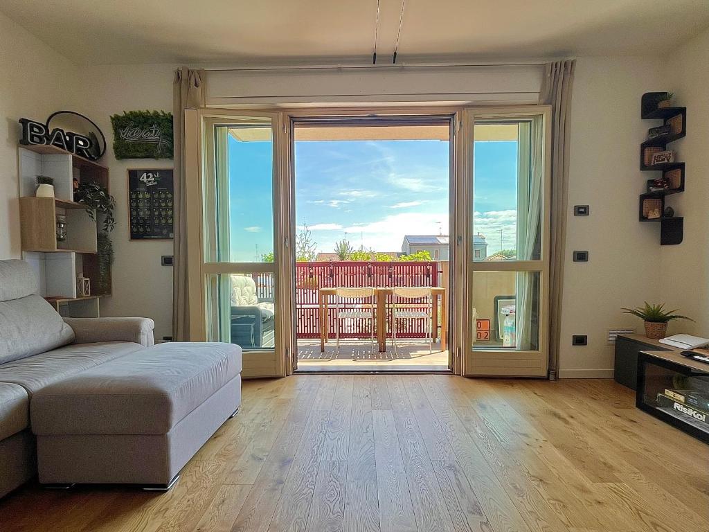 a living room with a couch and a sliding glass door at 081 Art corner - Milano ovest in Abbiategrasso
