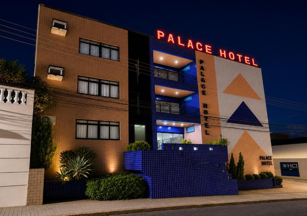 a palace hotel is lit up at night at Palace Hotel in Itajubá