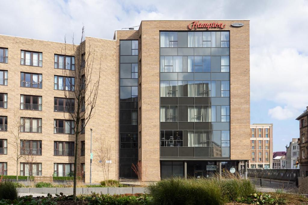 an office building with a sign on the side of it at Hampton By Hilton Edinburgh West End in Edinburgh
