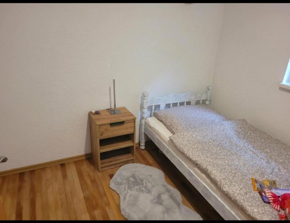 a bedroom with a bed and a wooden night stand at Holiday home Samir in Jajce