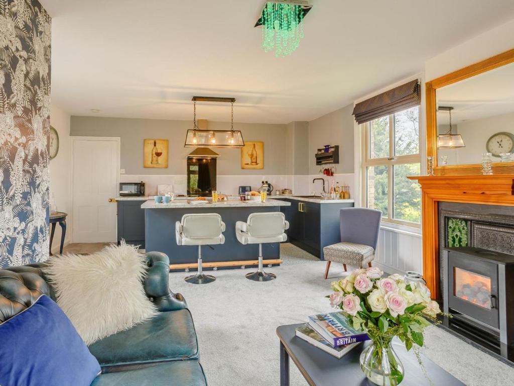 a living room with a fireplace and a kitchen at 1 Bed in York oc-91888 in Full Sutton