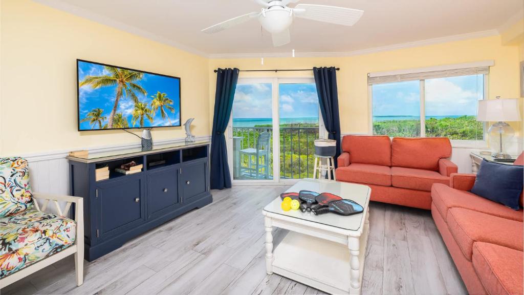 a living room with a couch and a tv at Sunrise Penthouse 3316 Ocean Pointe 1BR 2BA in Tavernier