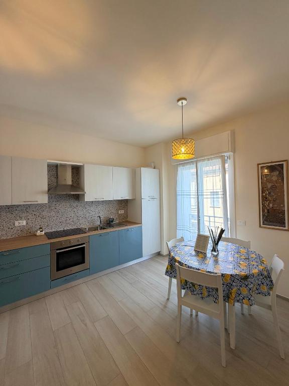 a kitchen with a table and a dining room at Modern Sea Apartment in Punta Marina