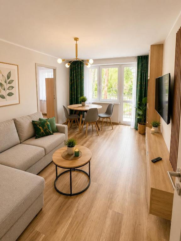 a living room with a couch and a table at Family Spot in Konin