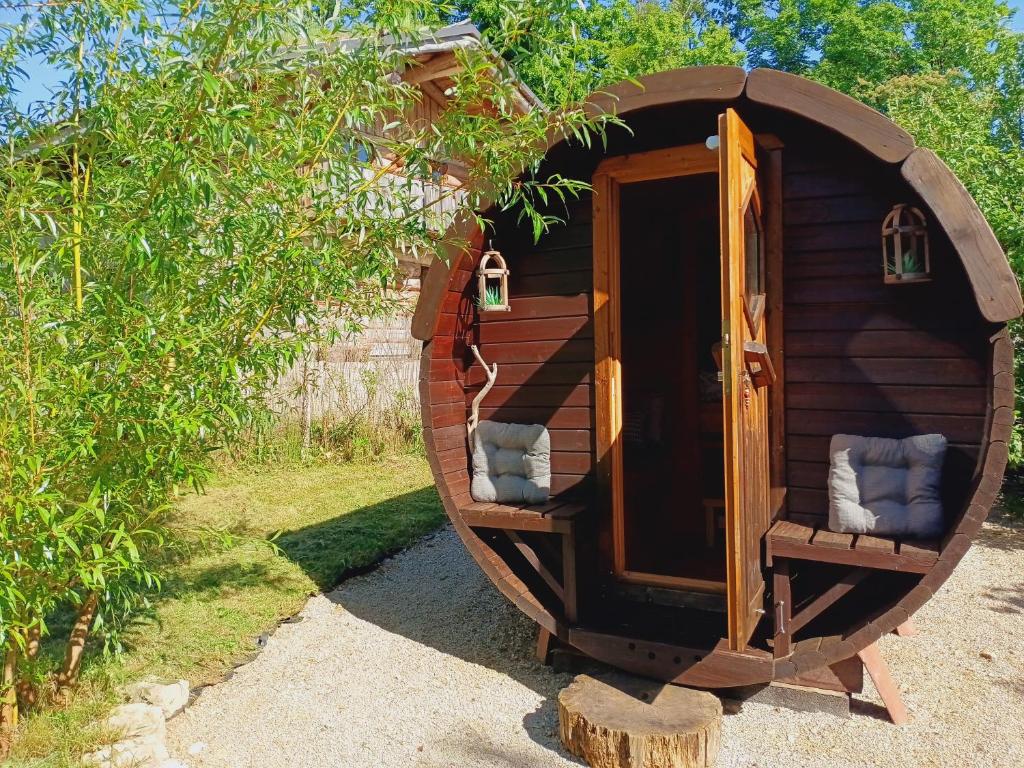 a small wooden house with two chairs in it at Lagarta , la buche in Étival