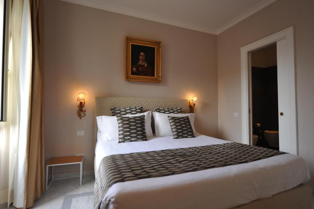 a bedroom with a large bed with black and white pillows at Angel Spagna Suite in Rome