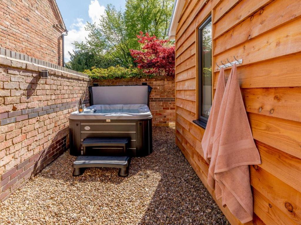 a backyard with a barbecue in a brick wall at 2 Bed in Ashbourne oc-81345 in Clifton