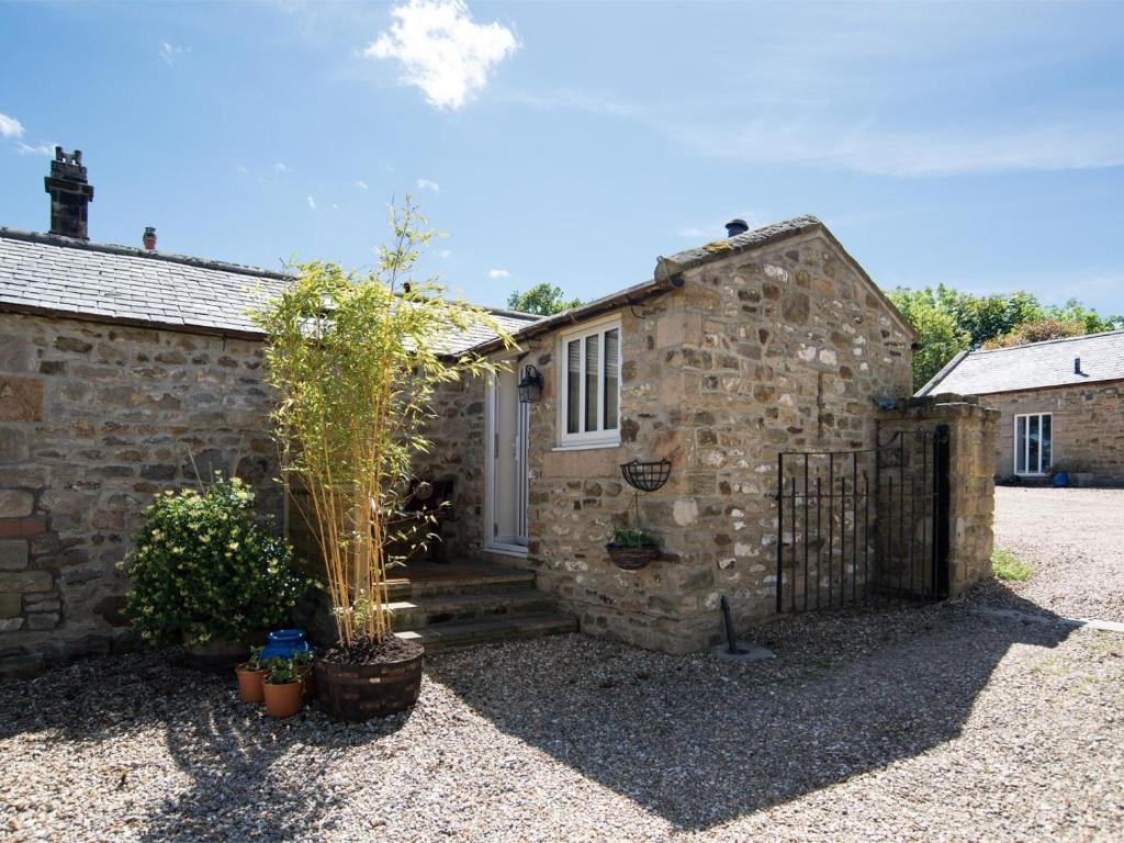 a stone building with a gate and a door at 1 Bed in Riding Mill oc-cn063 in Corbridge