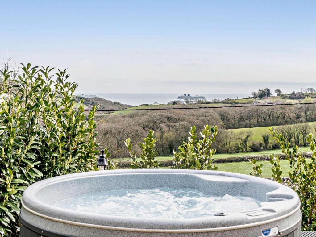 a jacuzzi tub in a garden with a view at 1 Bed in Weymouth oc-82099 in Osmington