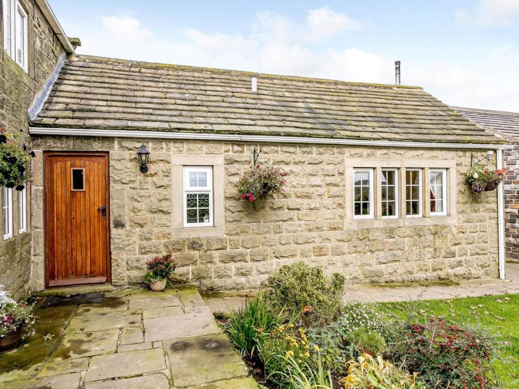 an old stone cottage with a wooden door at 1 Bed in Sheffield oc-48259 in Thurlstone