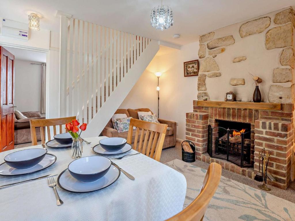a dining room with a table and a fireplace at 2 Bed in Freshwater oc-91606 in Freshwater