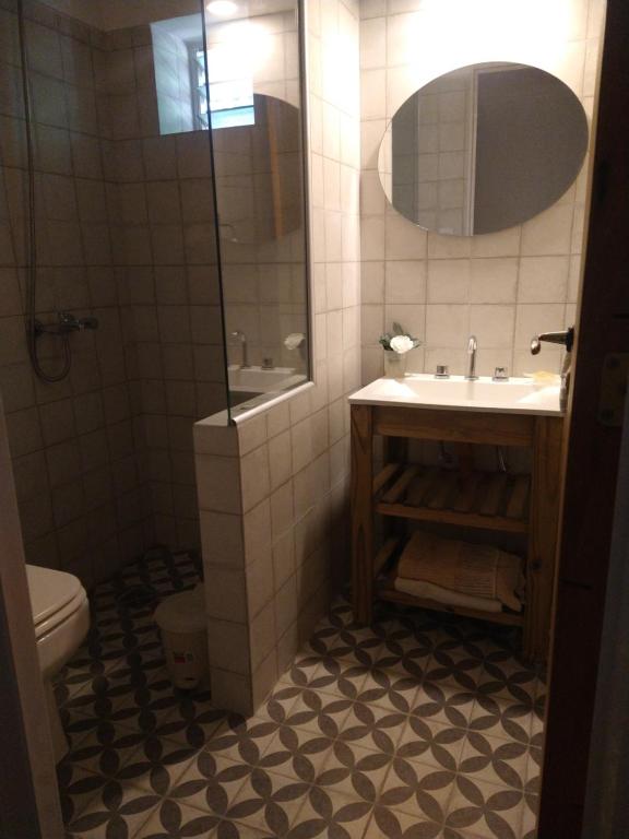 a bathroom with a sink and a toilet and a mirror at Monoambiente KALKI in Roldán