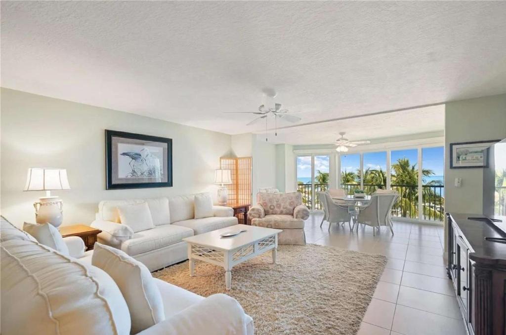 a living room with a white couch and a table at Islamorada Oceanfront Luxury Living in Islamorada
