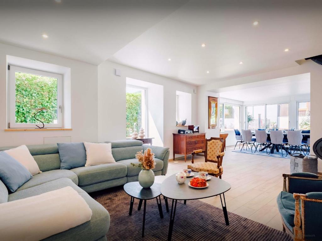 a living room with a couch and a table at Villa Le Cep - OVO Network in Menthon-Saint-Bernard