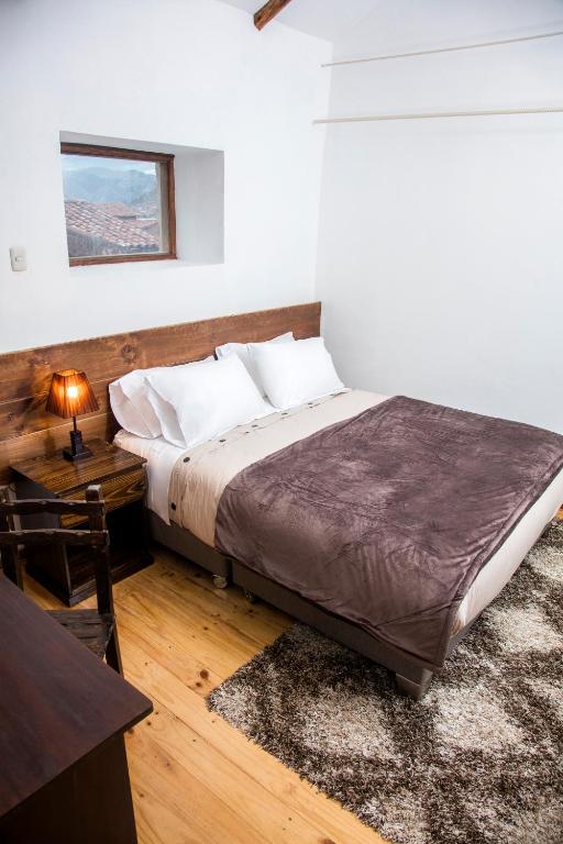 Postel nebo postele na pokoji v ubytování Hotel Casa Fierro Cusco