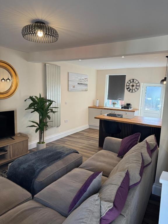 a living room with two beds and a television at Serene escape in Cleator Moor