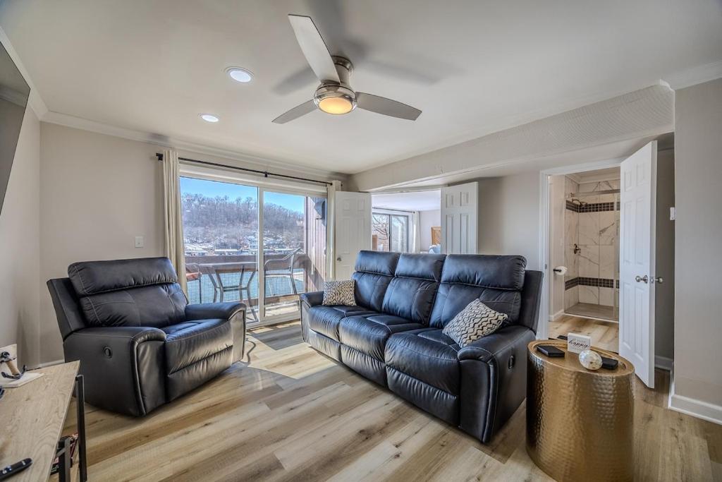 a living room with a couch and two chairs at 22 Mile Marker! Indoor/Outdoor Pools, Hot Tub! New in Osage Beach