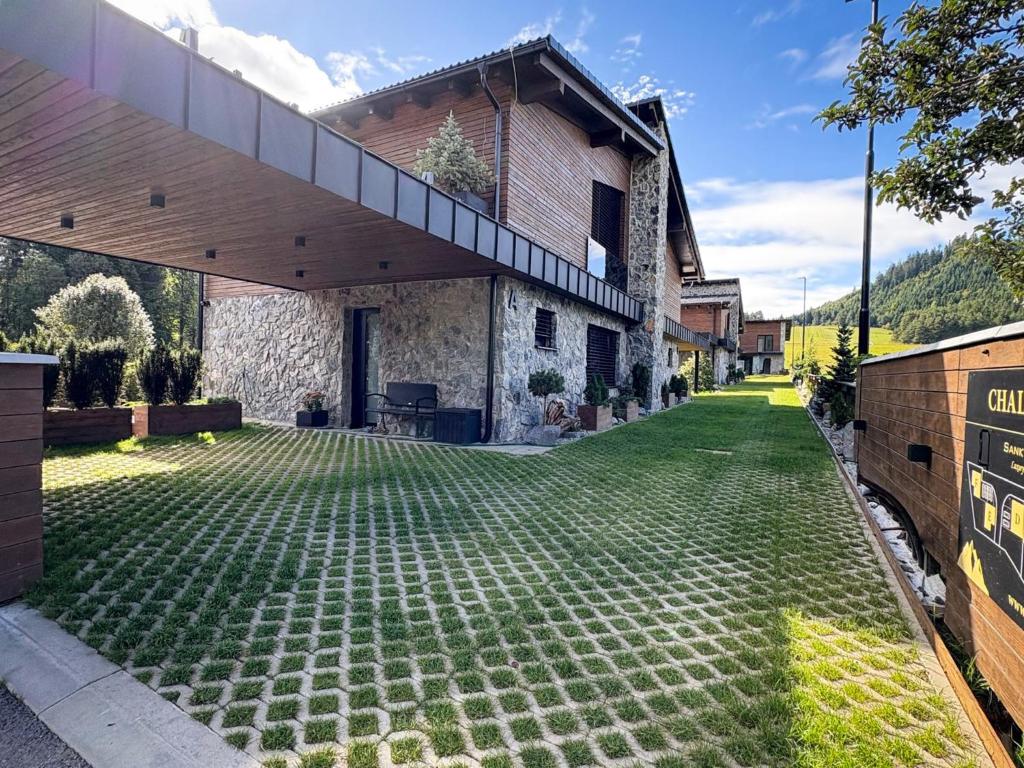 an external view of a house with a lawn at Chalet Johannes in Liptovský Ján