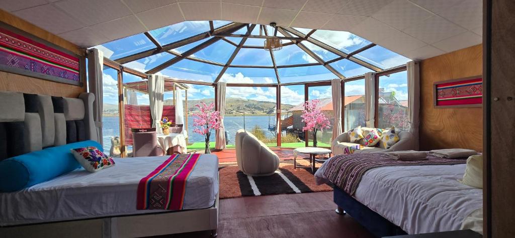a bedroom with two beds in a glass house at Titicaca Wara wara Lodge in Puno