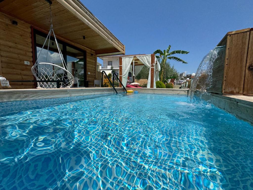 a swimming pool with a water slide in a house at The Pool Pushi Park in Ksamil