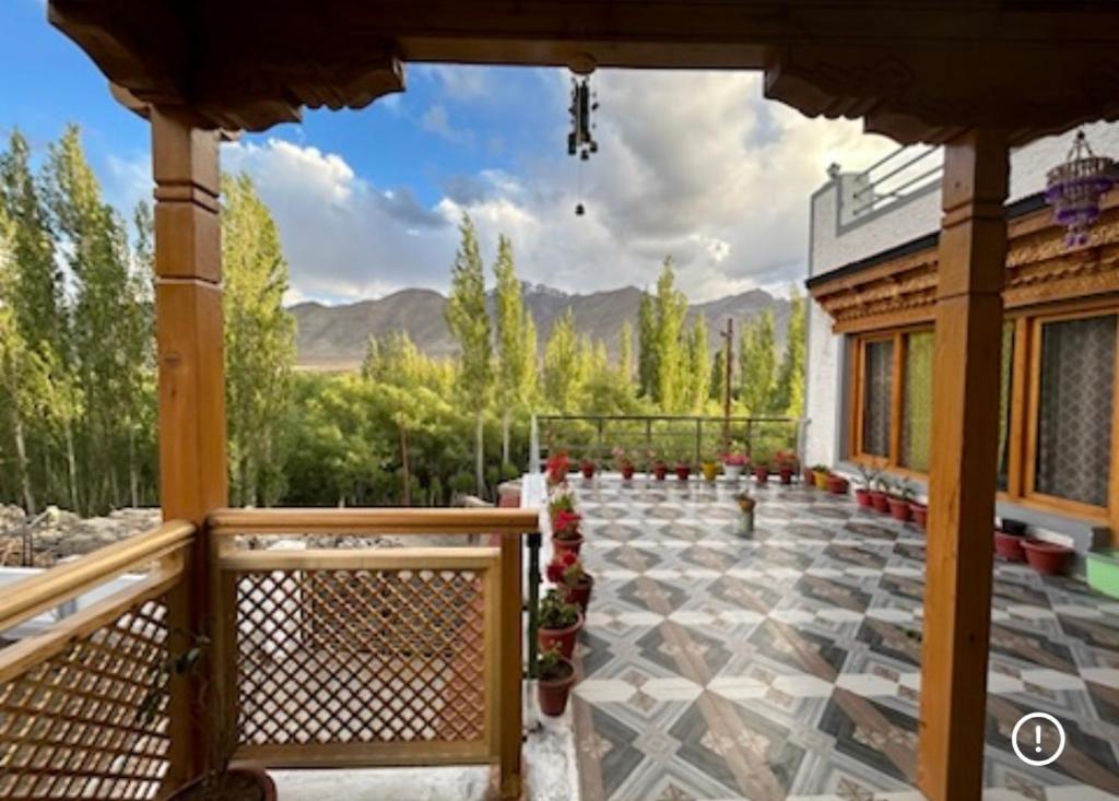 a porch of a house with a view of the mountains at Rongmo villa in Leh
